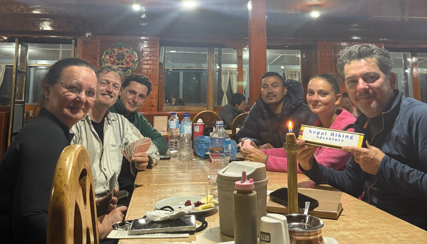 Trekkers enjoying dinner and celebrating their journey with Nepal Hiking Adventure during the Annapurna Circuit Trek.