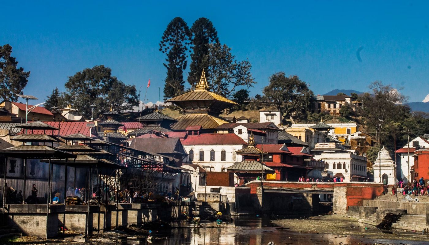 Pashupatinath Temple and cremation ghats on the Bagmati River in Kathmandu, Nepal – a sacred Hindu pilgrimage site visited during city sightseeing tours.