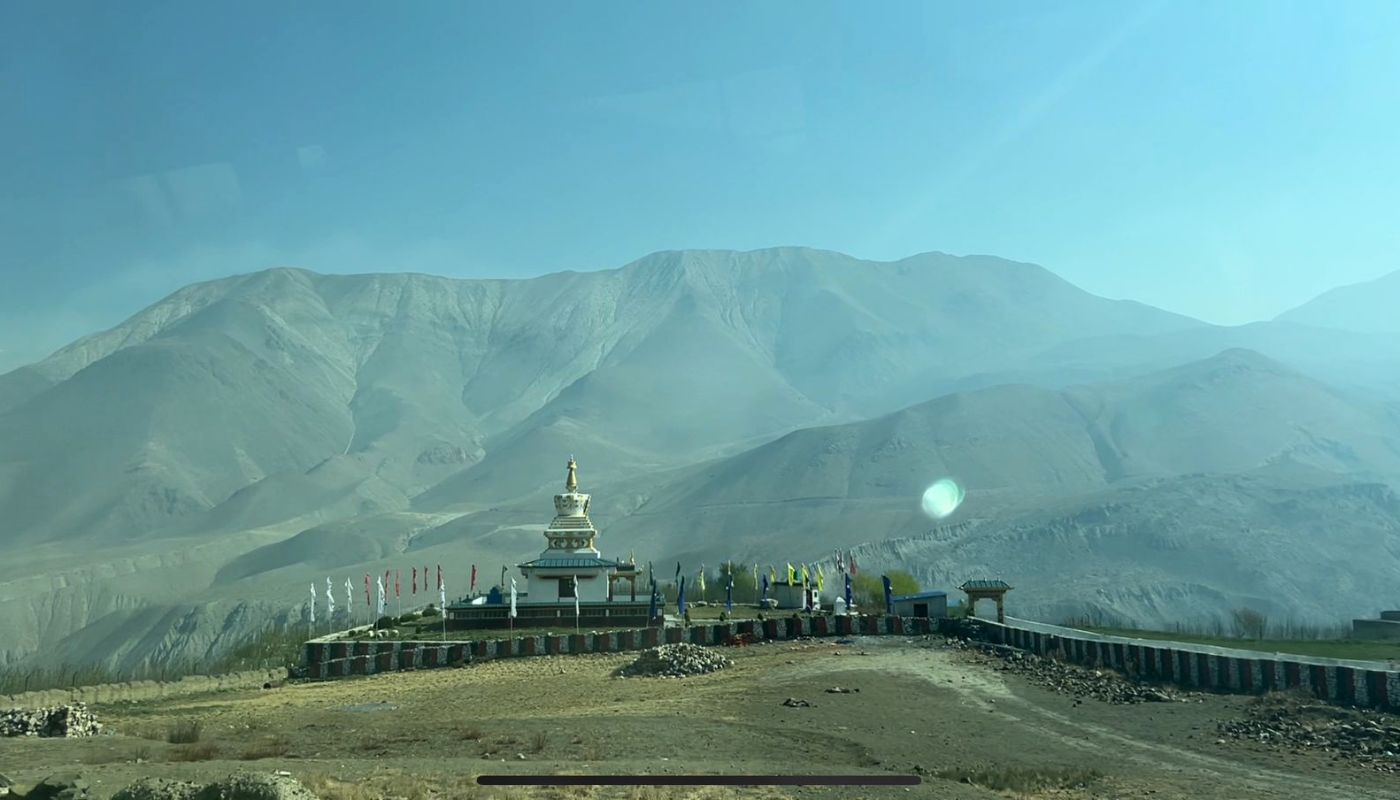 Buddhist stupa surrounded by barren mountains near Muktinath on the way to Jomsom and Tatopani, along the Annapurna Circuit Trek, Nepal.