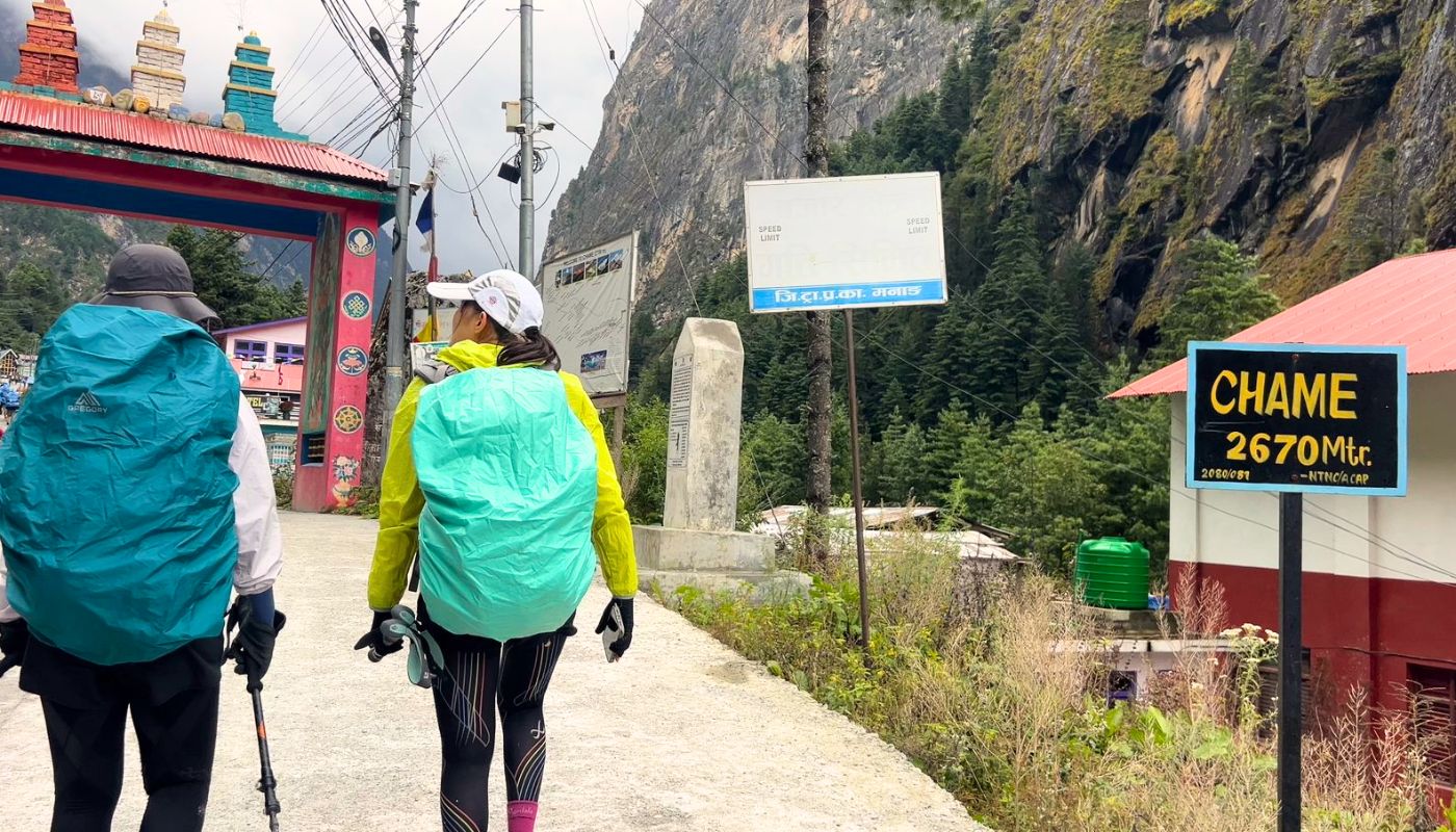 Trekkers walking through Chame village on Annapurna Circuit Short Trek.