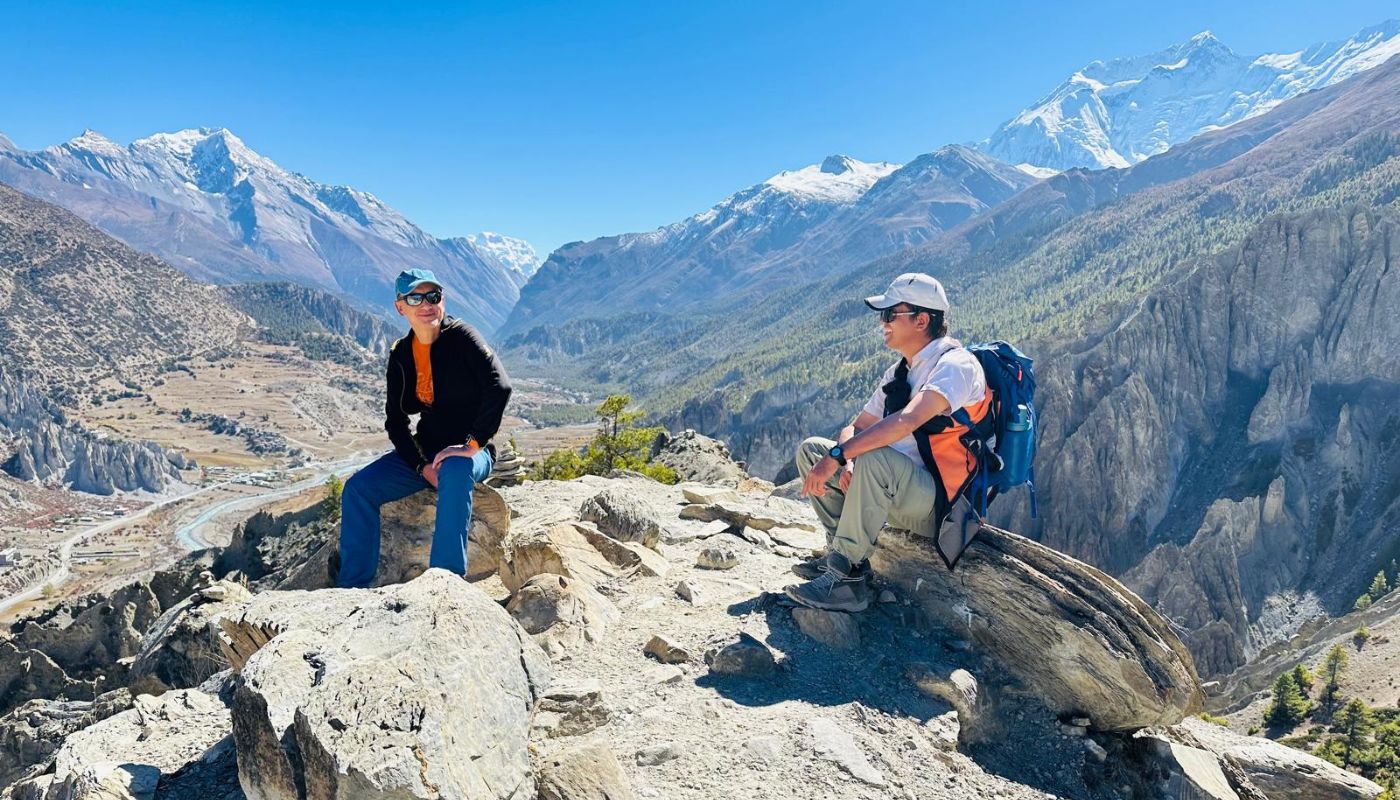 Trekkers in Manang village with stunning Himalayan mountain views during the Short Annapurna Circuit Trek.