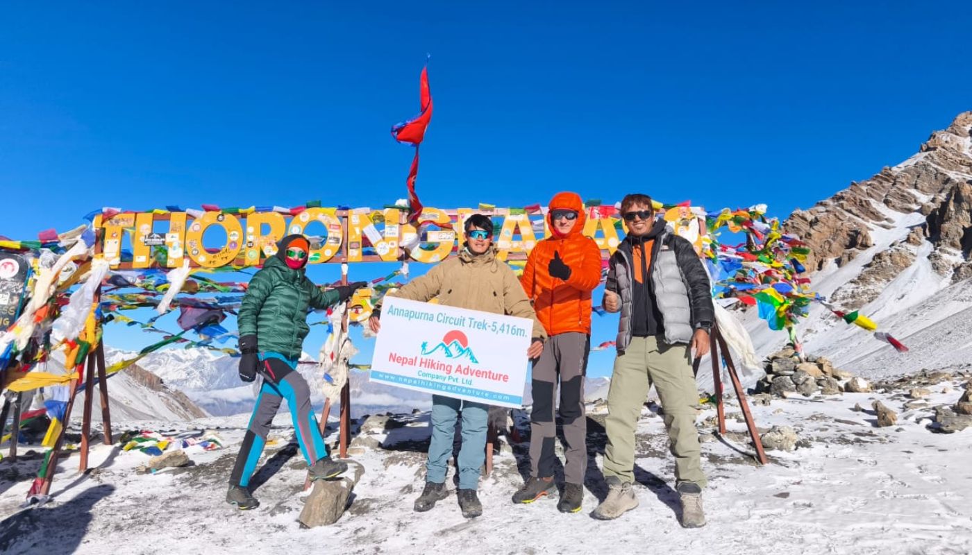Trekkers at Thorong La Pass, 5,416 meters, Annapurna Circuit Short Trek, Nepal - with Nepal Hiking Adventure Company