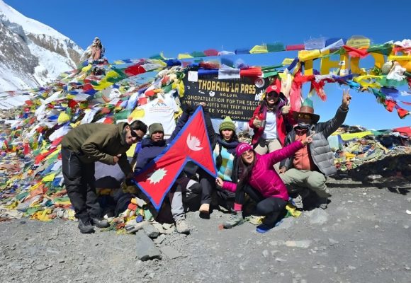 Nepal Flag with trekkers in mountains