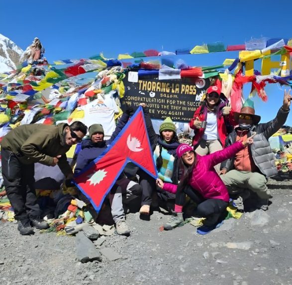 Nepal Flag with trekkers in mountains